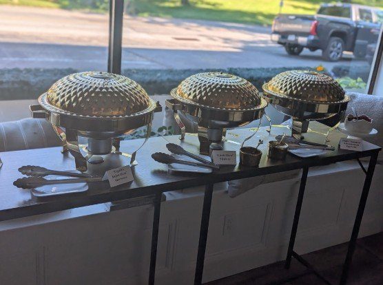 Chafing dishes with custom-named appetizers at a Main Line corporate happy hour