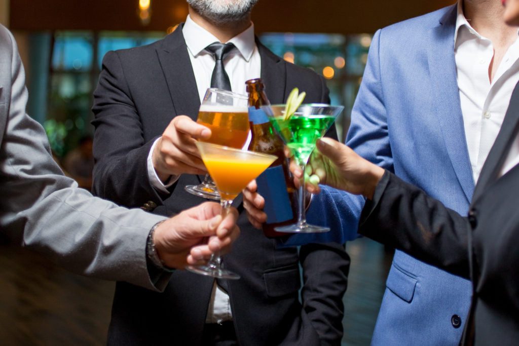 men enjoying wedding catered bar cocktails beer